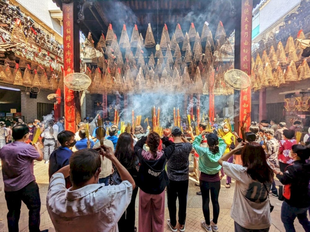 Locals lighting spiral incense and quietly praying in the Temple’s peaceful sanctity